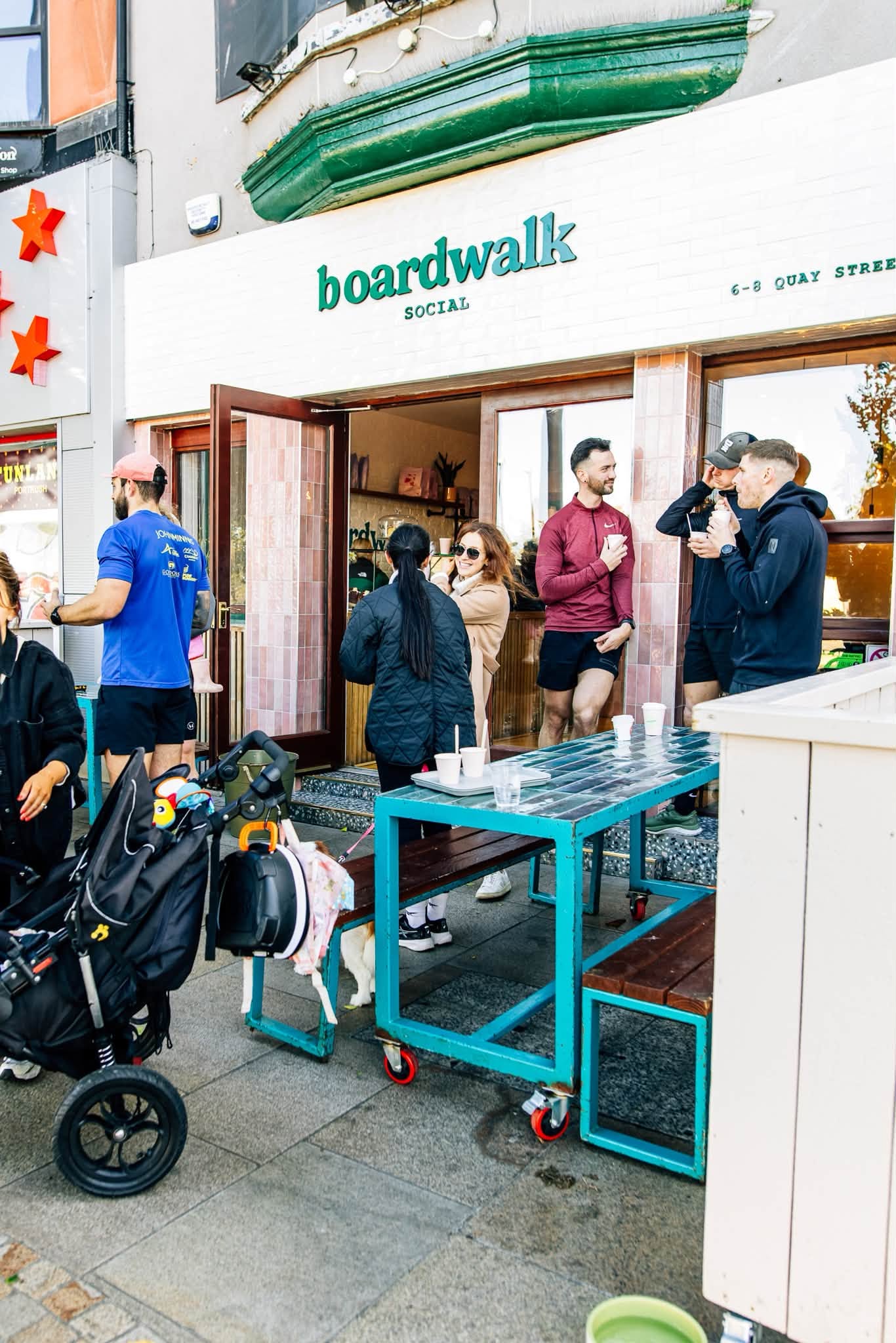 A busy weekend morning outside Boardwalk Social, coffees in hand after a run club